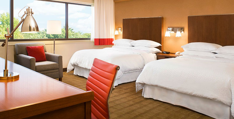 Queen room at the Minot location with convenient working desk with free Wi-Fi